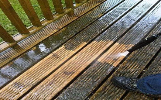 Clean decking and paving around garden sheds