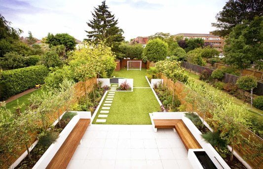 Long narrow zonal garden design with seating and kids area