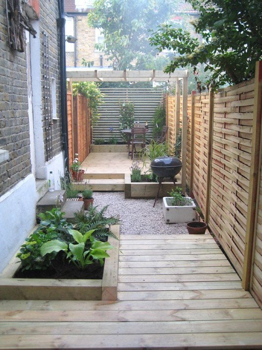 Long thin garden design with decking and a pergola